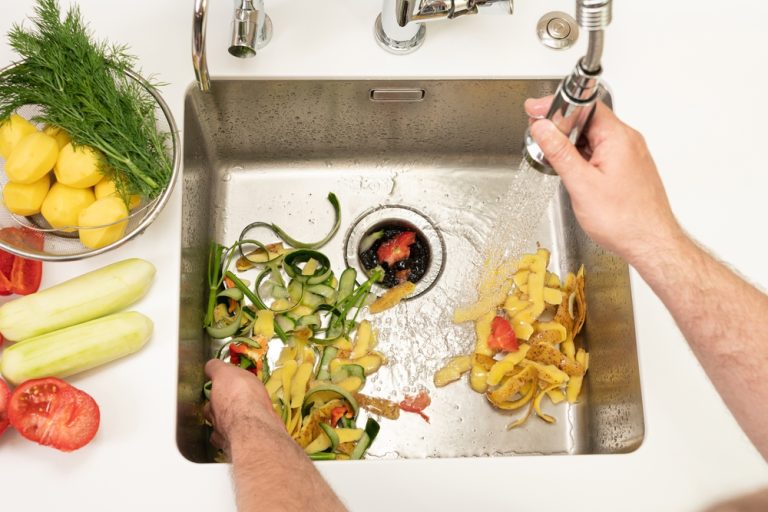 Food,Waste,After,Peeling,Vegetables,Is,Destroyed,Using,The,Disposer